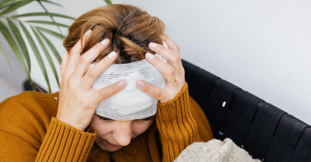A picture of a woman holding her bandaged head